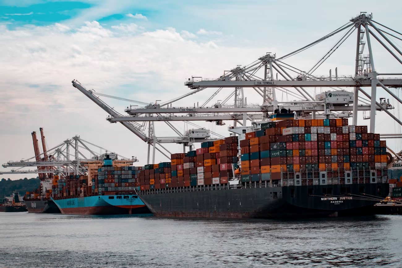 Containerschip wordt geladen aan een terminal met portaalkranen
